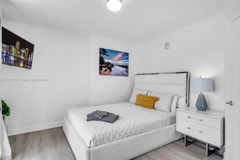 a bathroom with a granite countertop sink a toilet a mirror and shower