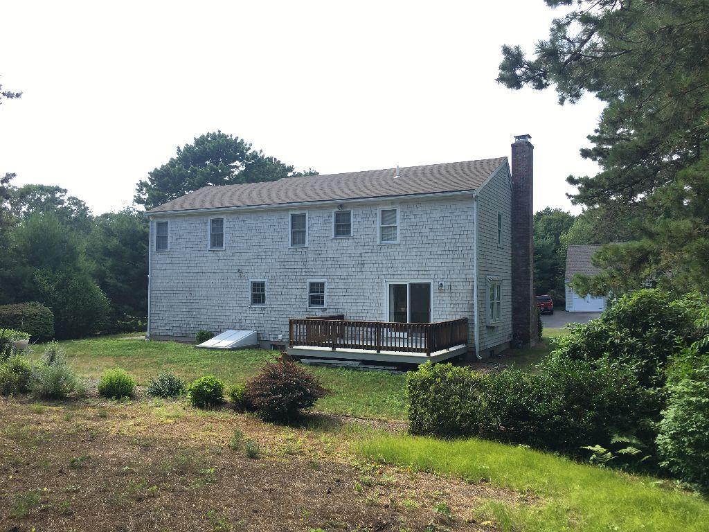 90 Meadowbrook Road Mashpee, MA 02649 - Photo 13 of 32 a front view of a house with garden