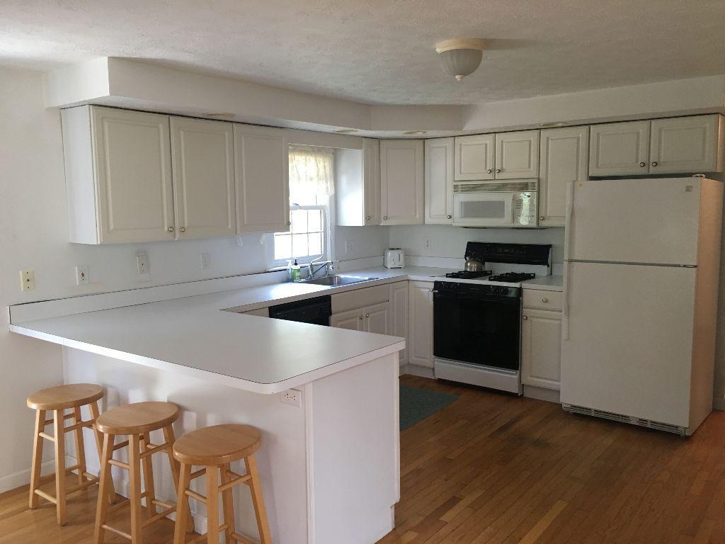 90 Meadowbrook Road Mashpee, MA 02649 - Photo 17 of 32 a kitchen with stainless steel appliances granite countertop a sink stove and refrigerator