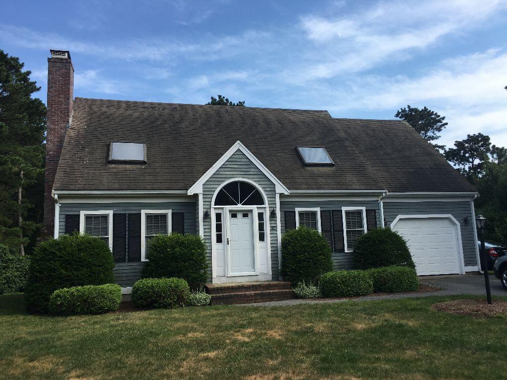 90 Meadowbrook Road Mashpee, MA 02649 - Photo 2 of 32 a front view of a house with a yard and garage