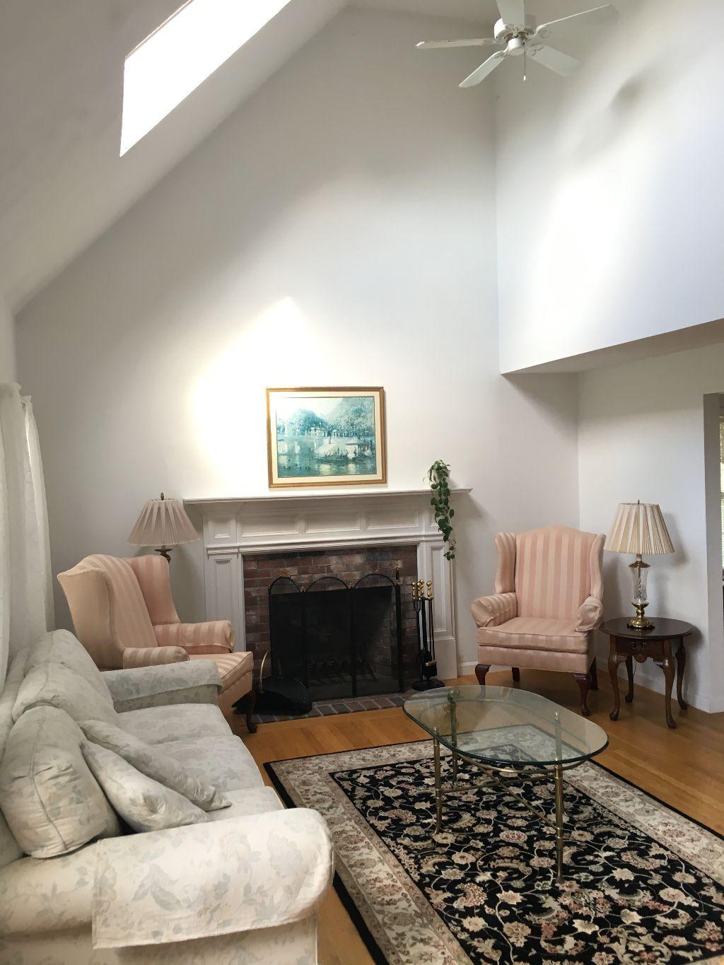 90 Meadowbrook Road Mashpee, MA 02649 - Photo 27 of 32 a living room with furniture and a fireplace