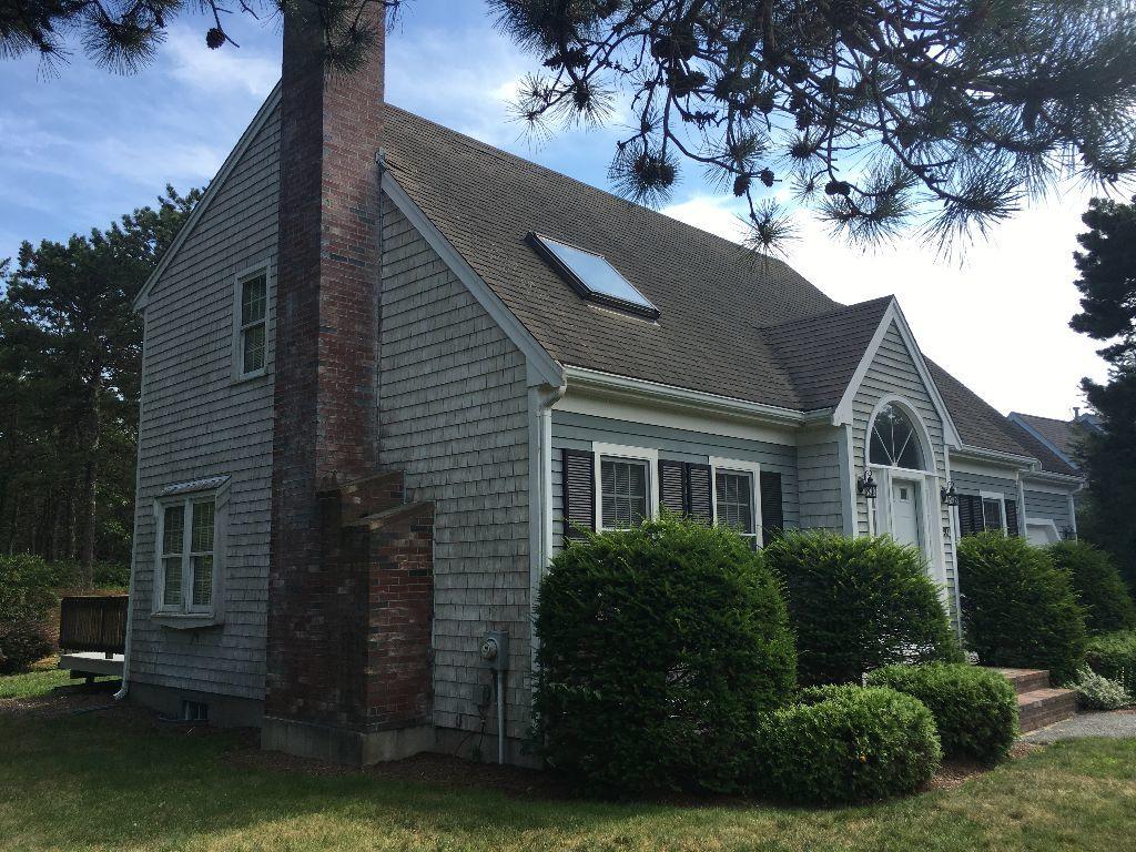 90 Meadowbrook Road Mashpee, MA 02649 - Photo 3 of 32 a front view of a house with a garden