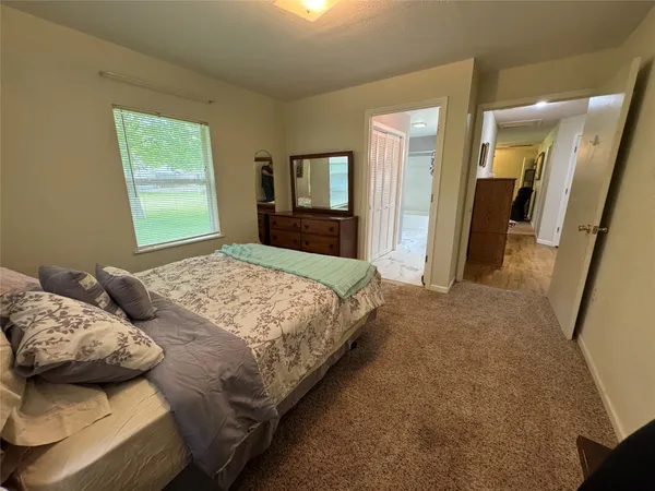 a bedroom with bed and window