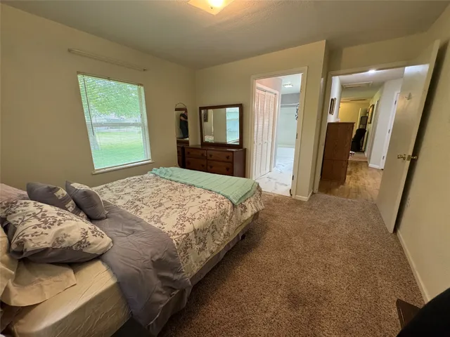 a bedroom with bed and window