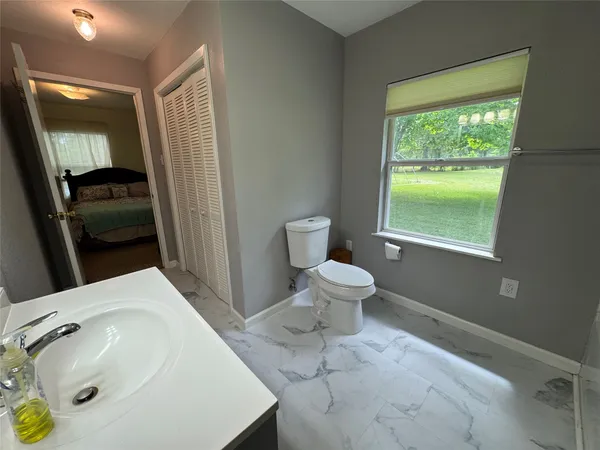 a bathroom with a sink toilet and vanity