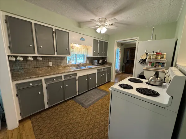 a kitchen with a sink appliances and cabinets