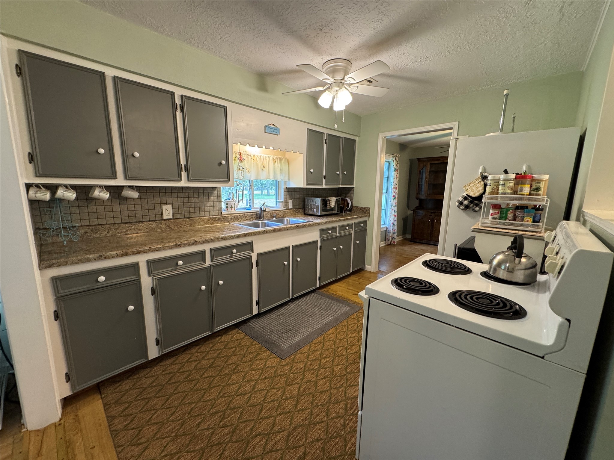 2300 Bowler Road Waller, TX 77484 - Photo 19 of 34 a kitchen with a sink appliances and cabinets
