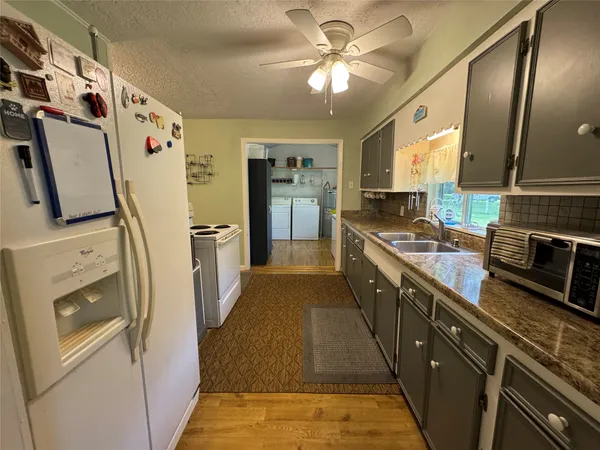 a kitchen with stainless steel appliances a stove a sink and a refrigerator