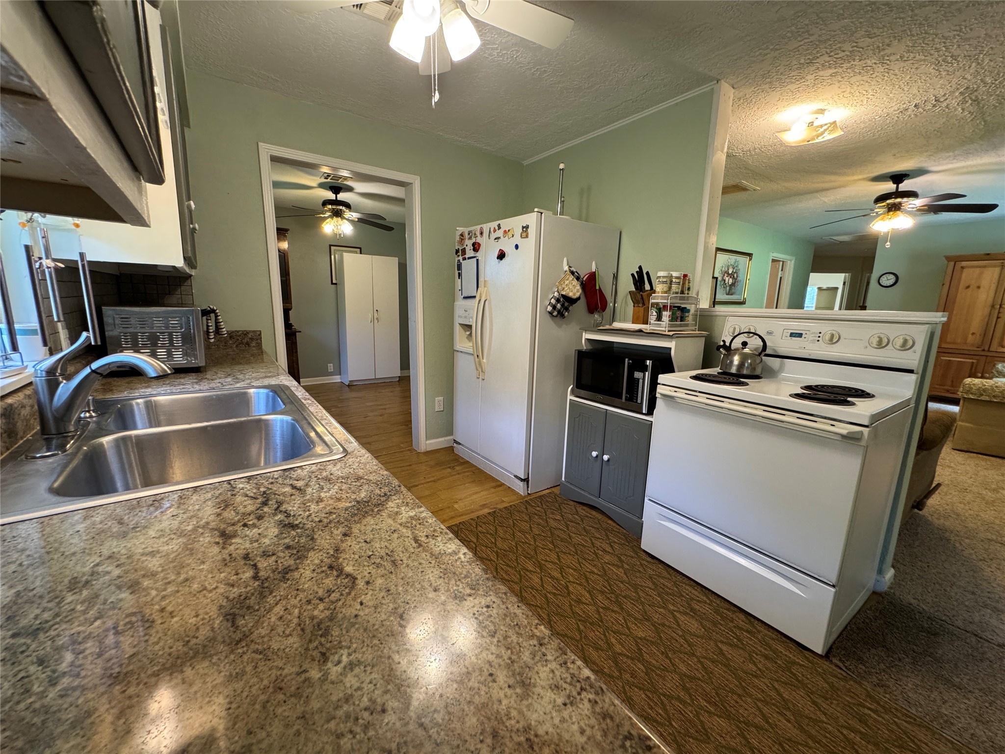 2300 Bowler Road Waller, TX 77484 - Photo 21 of 34 a kitchen that has a sink and a stove top oven