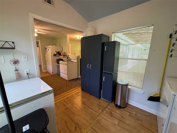 a kitchen with a sink appliances and cabinets
