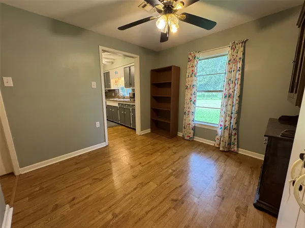 a view of a room with wooden floor closet and a window