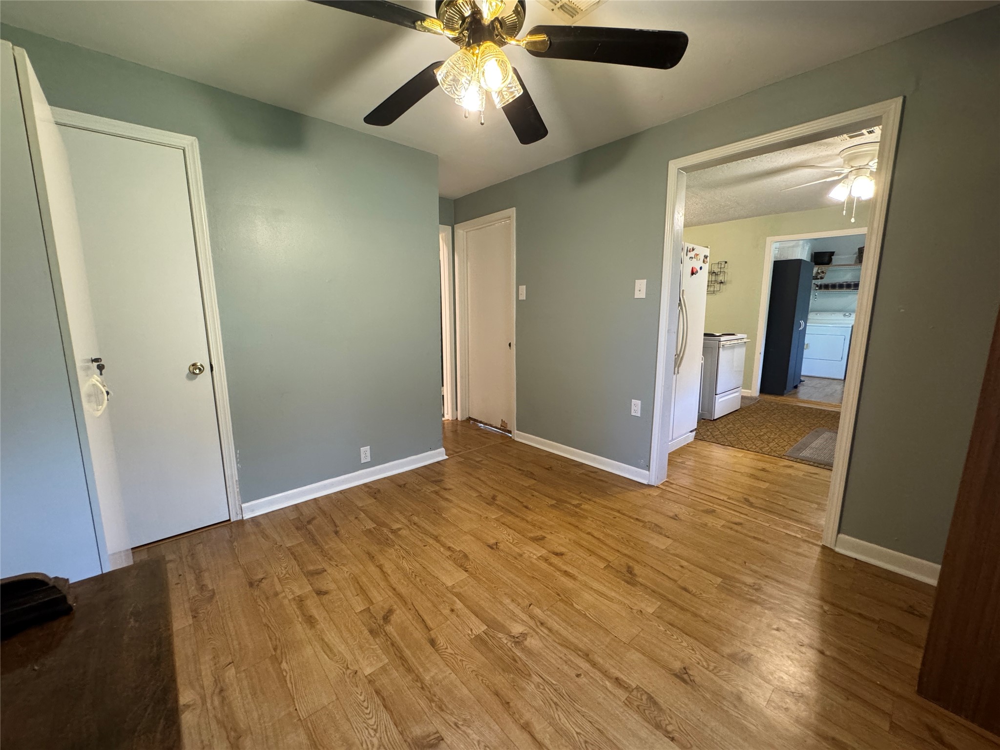 2300 Bowler Road Waller, TX 77484 - Photo 26 of 34 a view of a big room with wooden floor and a ceiling fan