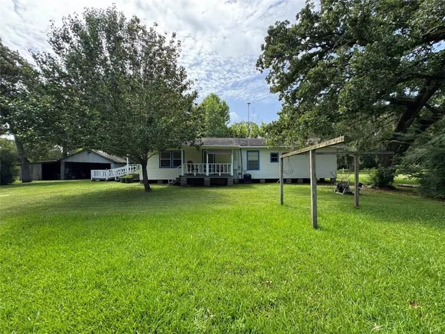 a view of a house with a yard porch and sitting area