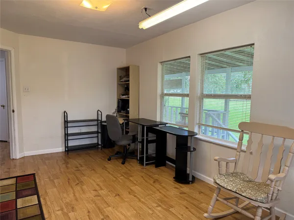 a view of a workspace with furniture and a window