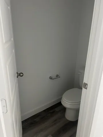 a white toilet sitting next to a sink