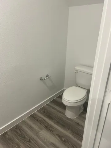 a white toilet sitting next to a shower
