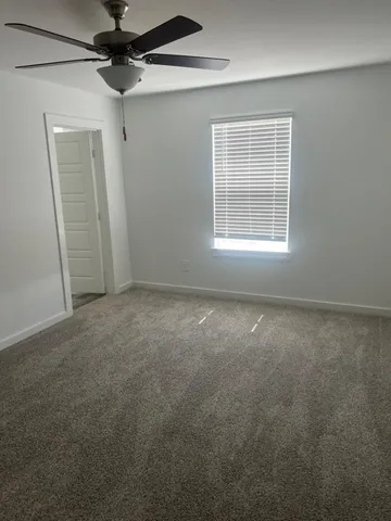 an empty room with windows and entrance