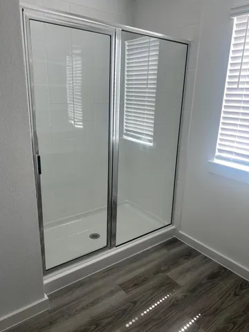 a view of a small space with wooden floor and a window