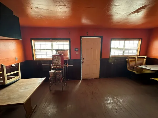 a view of a livingroom with furniture window and wooden floor