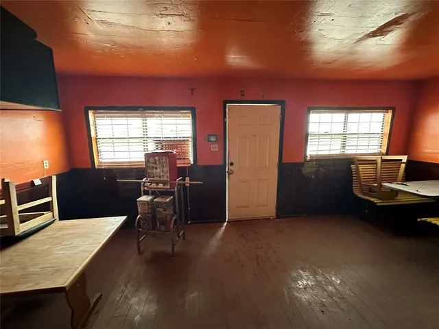 a view of a livingroom with furniture window and wooden floor