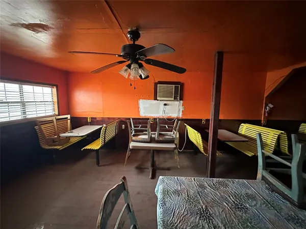 a living room with patio a table and chairs with wooden floor