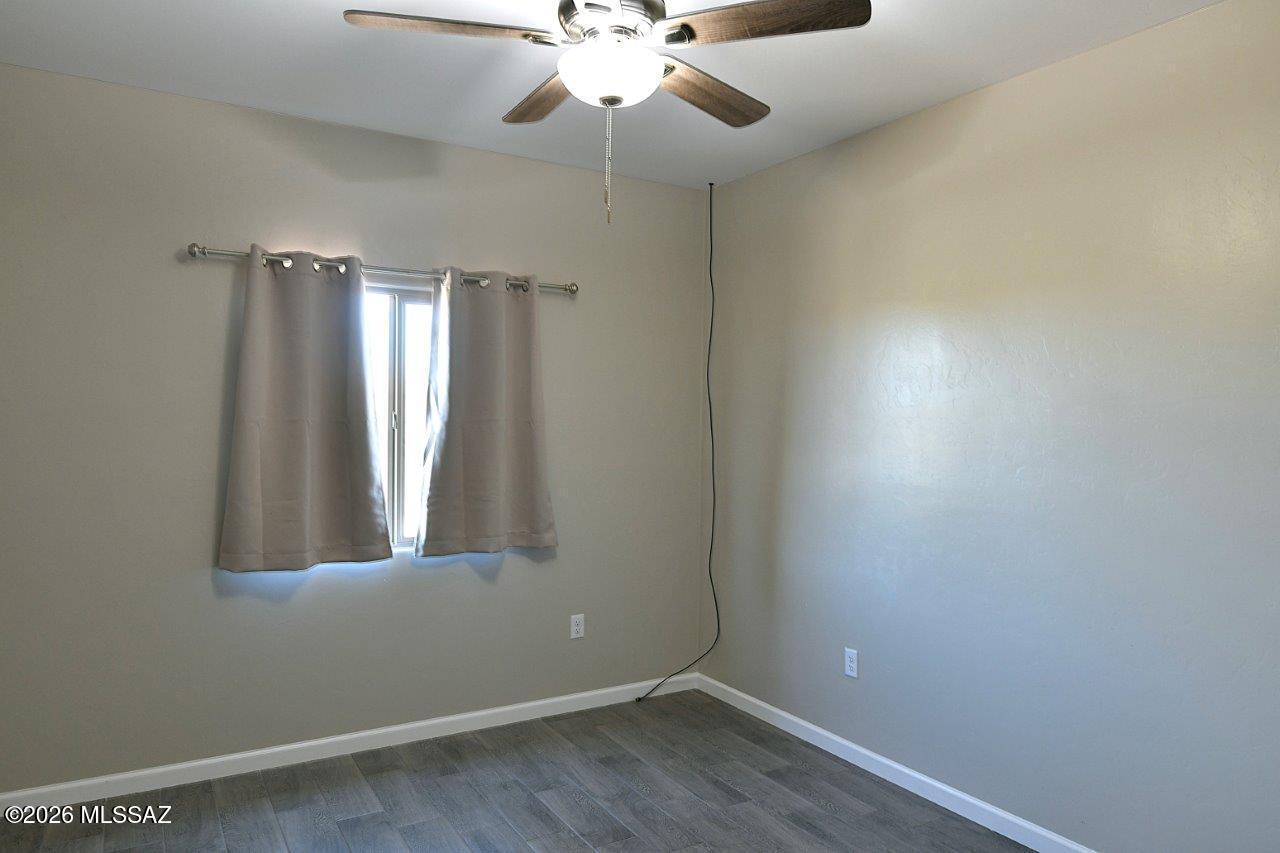 1091 North Vail View Road Vail, AZ 85641 - Photo 26 of 43 wooden floor in an empty room with a window