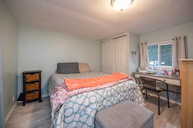 a bedroom with a bed and a table in it