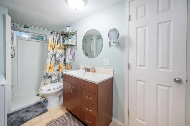 a bathroom with a toilet a sink and a shower