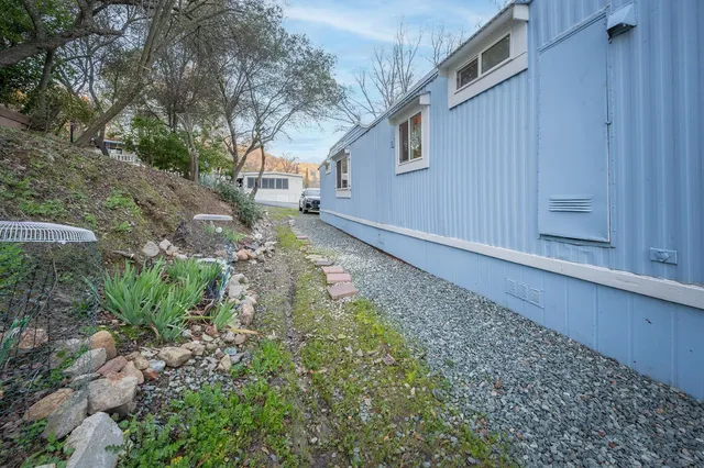 a view of a porch with chairs and potted plants