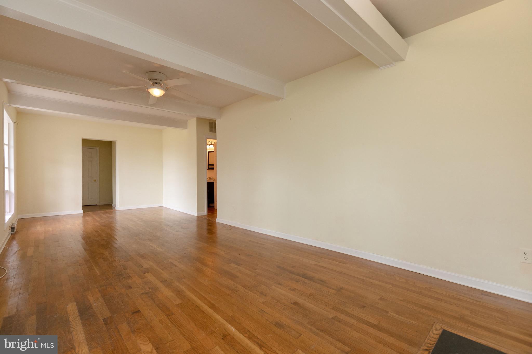 15414 Peach Orchard Road Silver Spring, MD 20905 - Photo 2 of 19 a view of empty room with wooden floor and fan