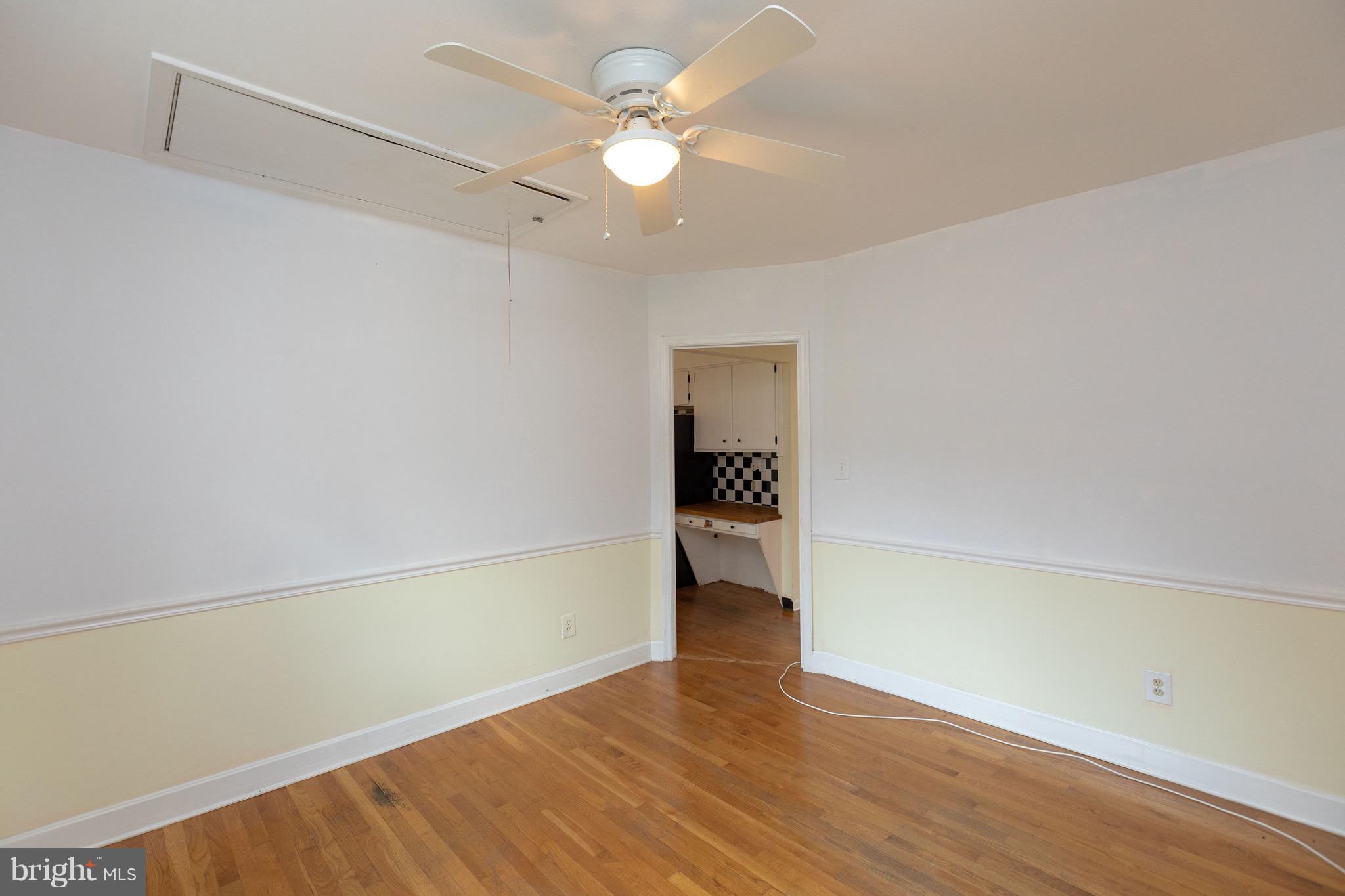 15414 Peach Orchard Road Silver Spring, MD 20905 - Photo 11 of 19 a view of an empty room with wooden floor