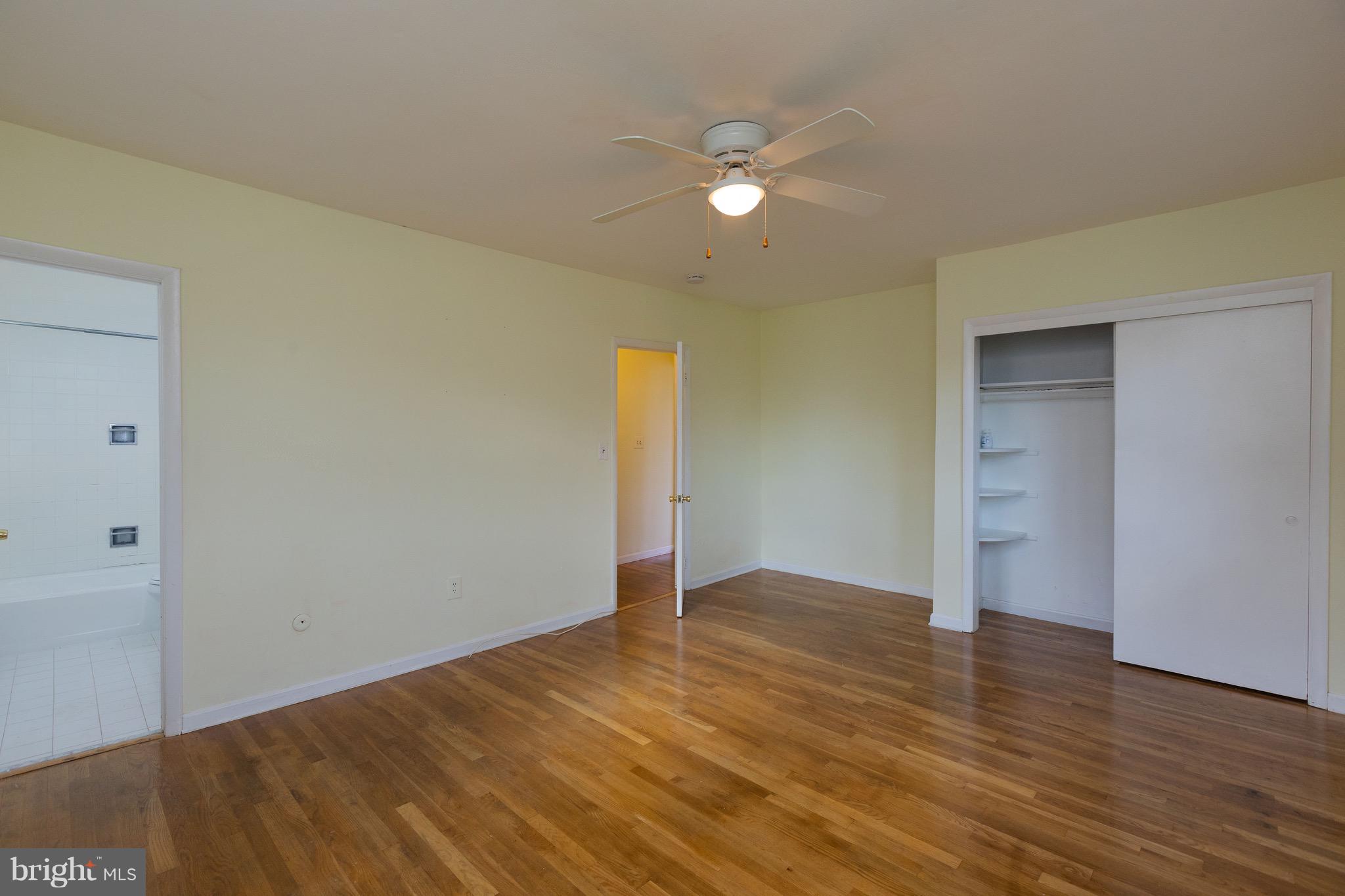 15414 Peach Orchard Road Silver Spring, MD 20905 - Photo 15 of 19 an empty room with wooden floor and closet