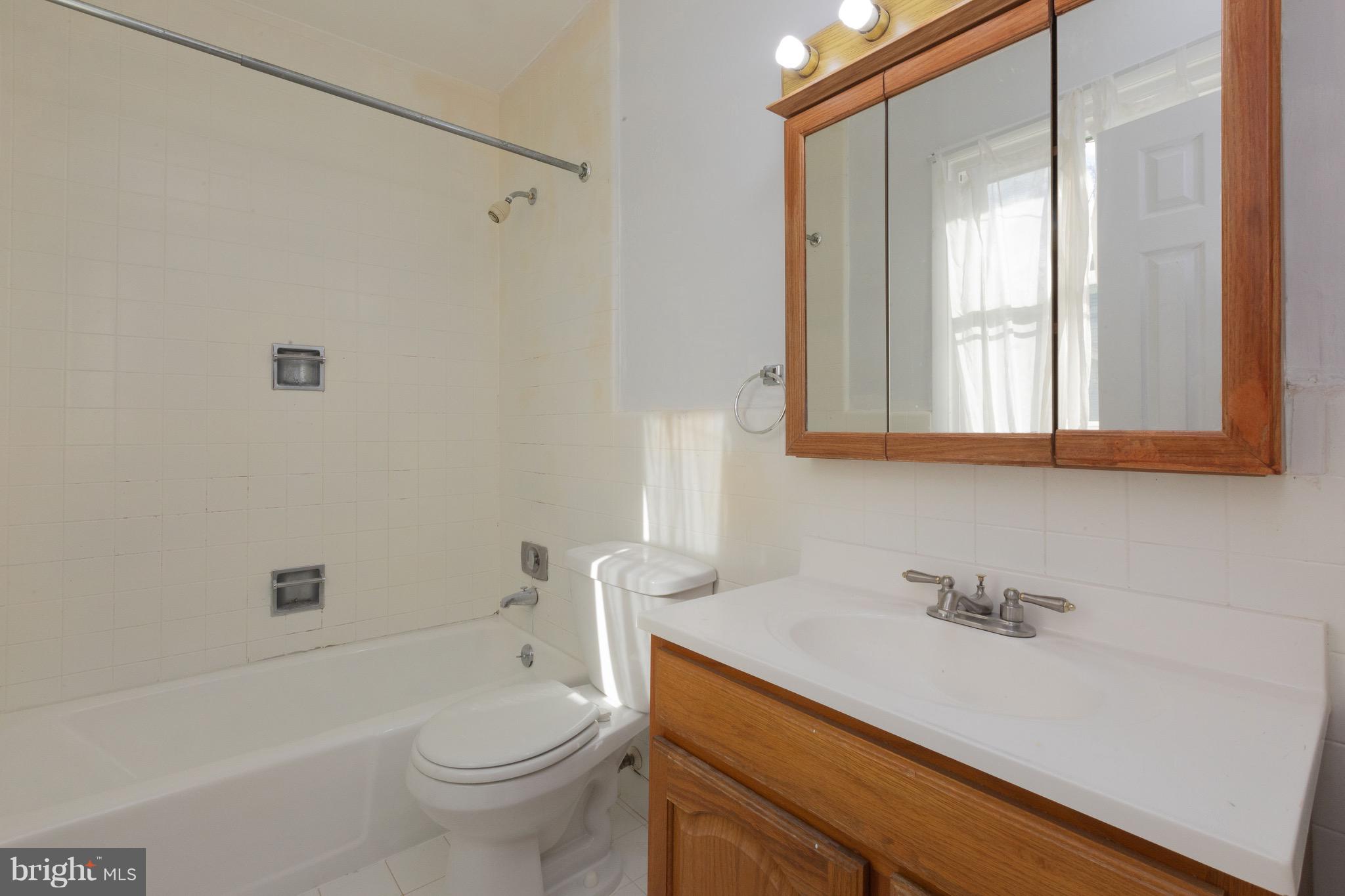 15414 Peach Orchard Road Silver Spring, MD 20905 - Photo 16 of 19 a bathroom with a sink a toilet and shower
