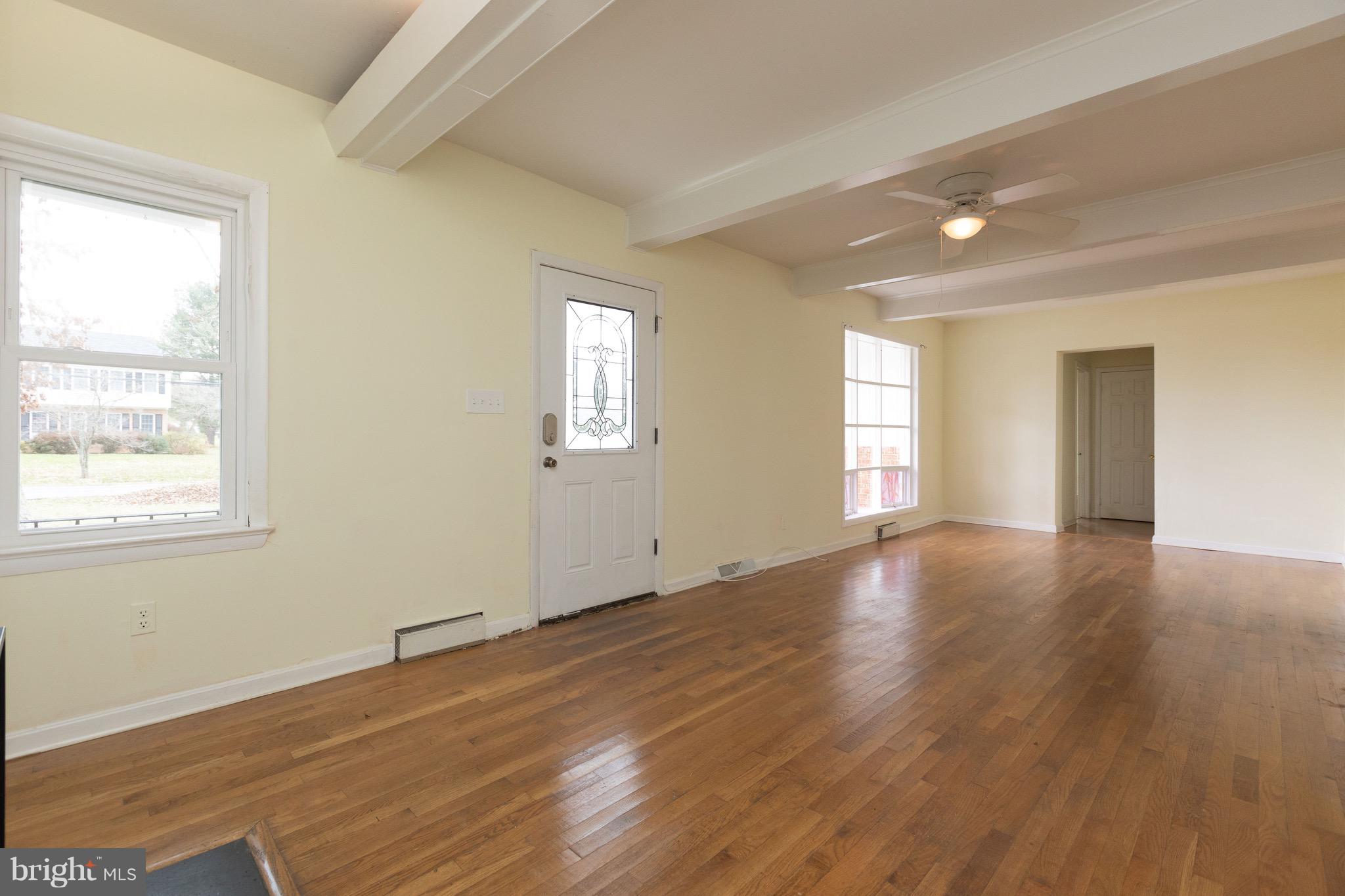 15414 Peach Orchard Road Silver Spring, MD 20905 - Photo 3 of 19 a view of an empty room with wooden floor and window