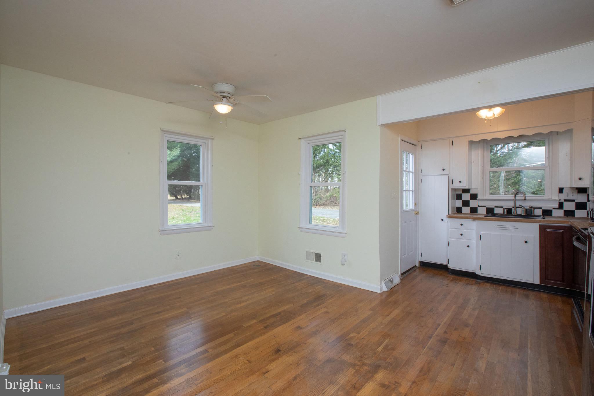 15414 Peach Orchard Road Silver Spring, MD 20905 - Photo 5 of 19 a view of a kitchen with wooden floor and a window