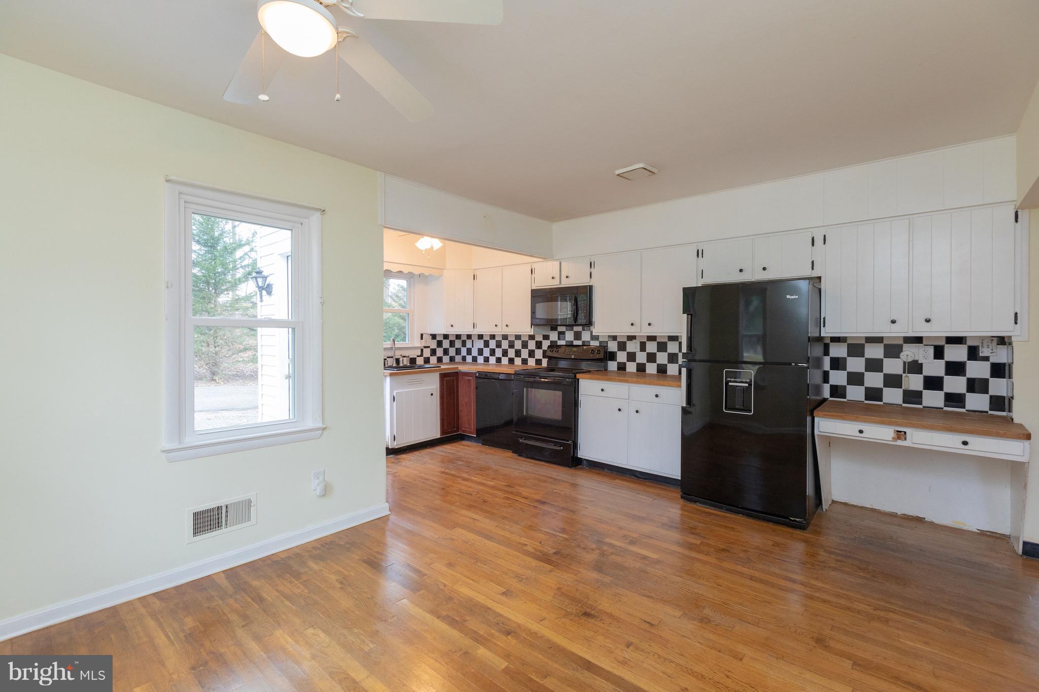 15414 Peach Orchard Road Silver Spring, MD 20905 - Photo 6 of 19 a kitchen with a refrigerator and a stove top oven