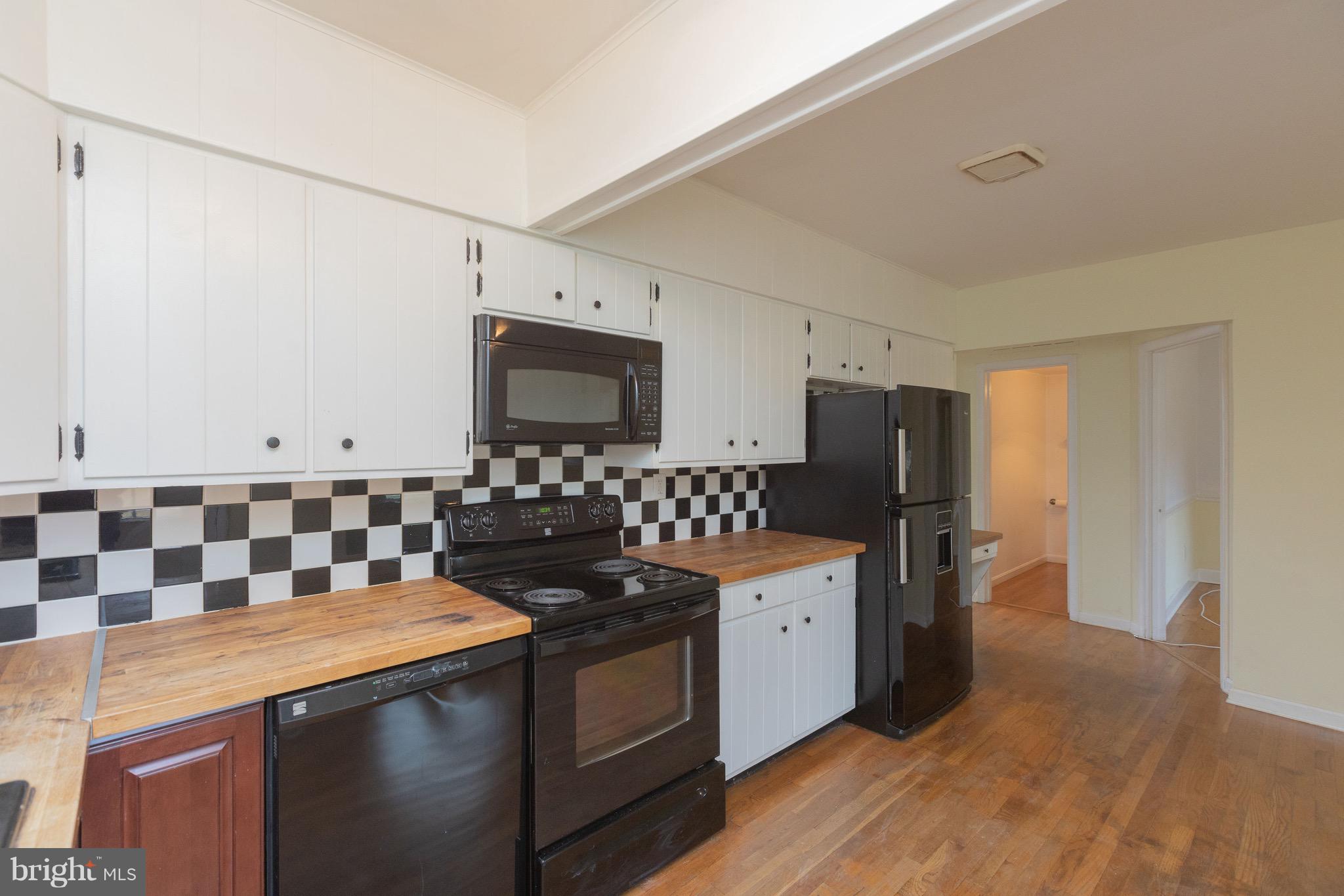 15414 Peach Orchard Road Silver Spring, MD 20905 - Photo 7 of 19 a kitchen with a sink stove and refrigerator