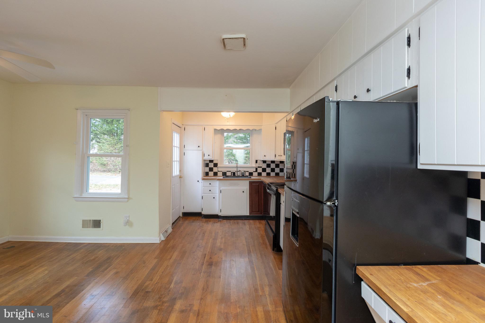 15414 Peach Orchard Road Silver Spring, MD 20905 - Photo 8 of 19 a kitchen with a refrigerator wooden floor and a sink