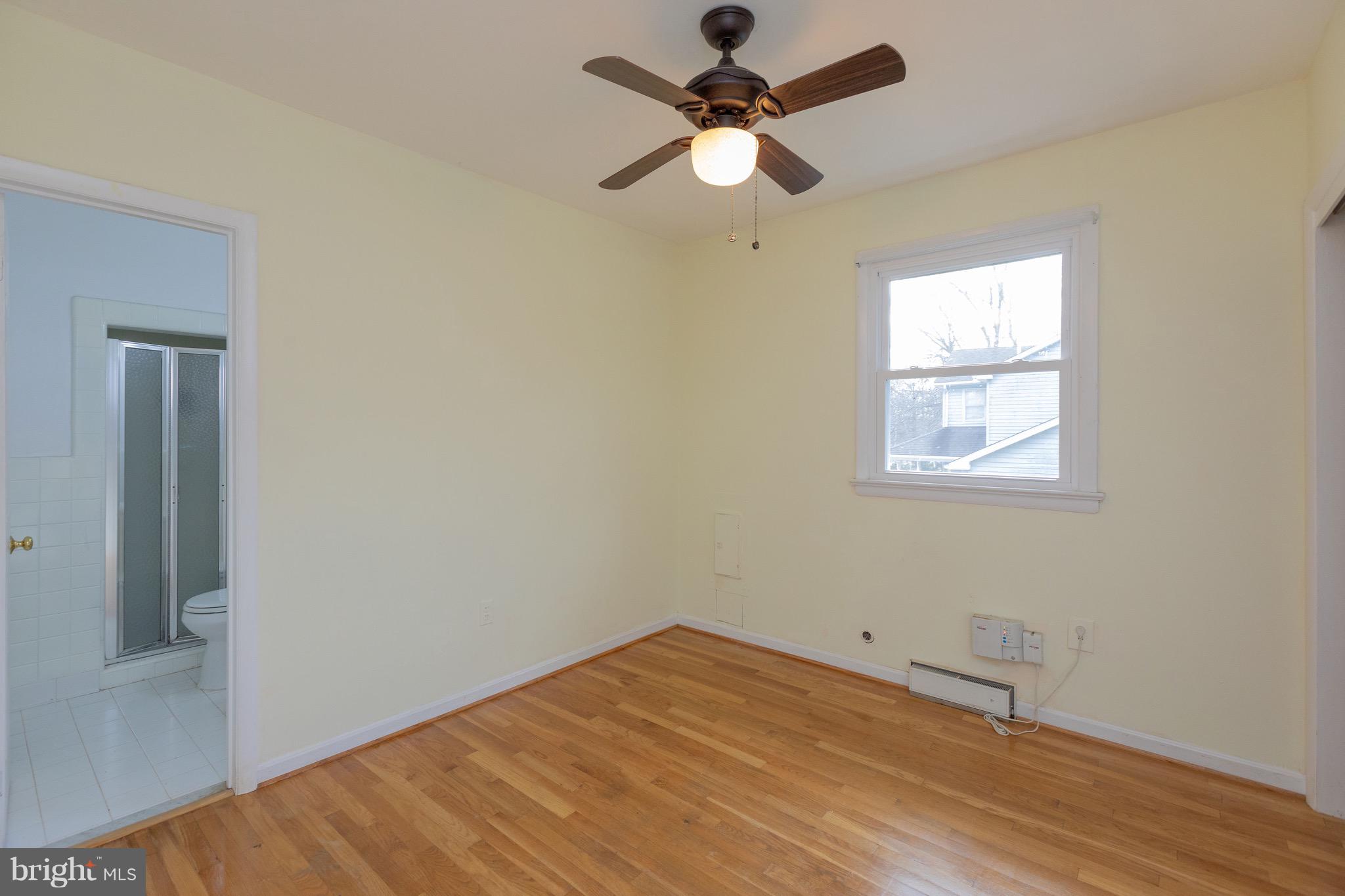 15414 Peach Orchard Road Silver Spring, MD 20905 - Photo 10 of 19 an empty room with a window and a fan