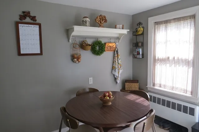 a view of a dining room with furniture and window