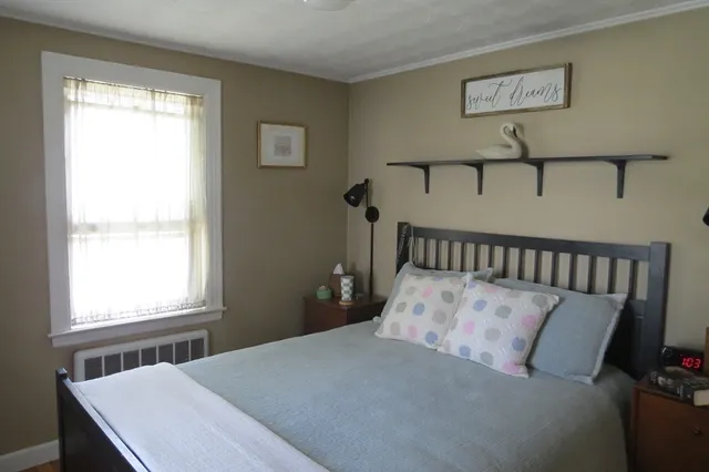 a bed sitting in a bedroom next to a window