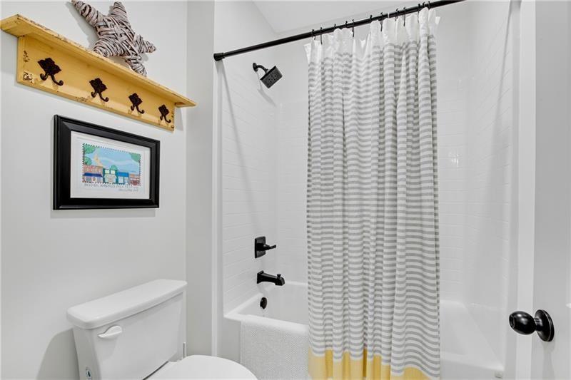 485 Delaperriere Loop Jefferson, GA 30549 - Photo 43 of 71 a bathroom with a toilet and a shower curtain