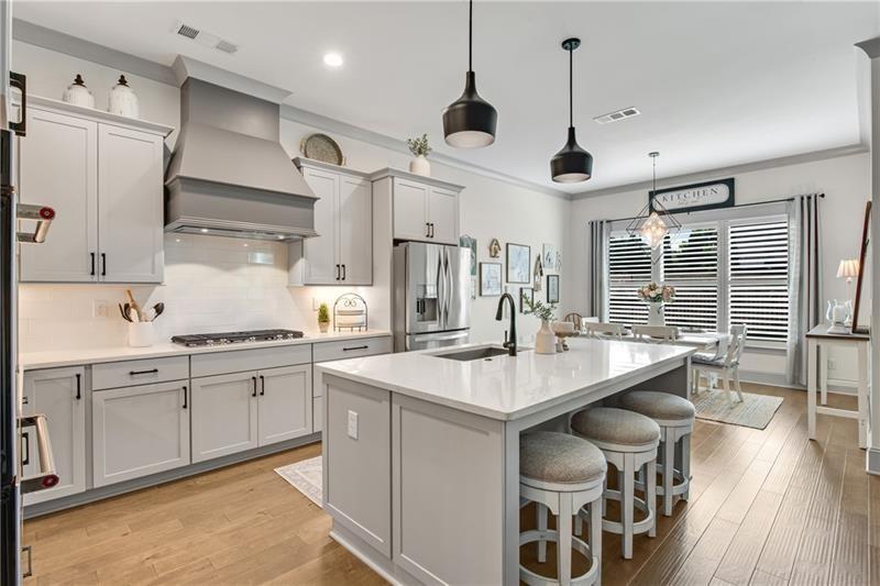 485 Delaperriere Loop Jefferson, GA 30549 - Photo 9 of 71 a open kitchen with stainless steel appliances granite countertop a sink a stove and a refrigerator