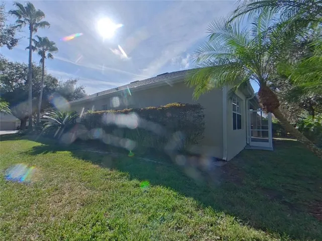 a backyard of a house with plants and outdoor seating
