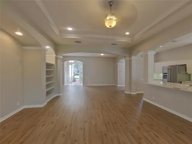 a view of a hallway with wooden floors and a fireplace