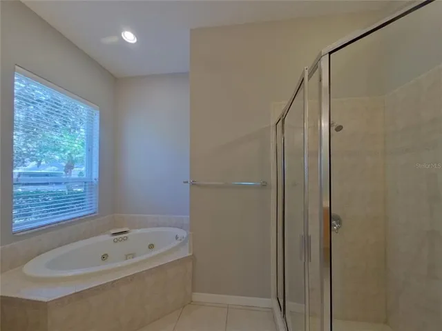 a bathroom with a tub shower and sink