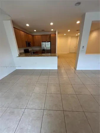 a view of a hall with kitchen