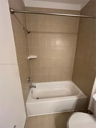 a bathroom with a tub and a shower