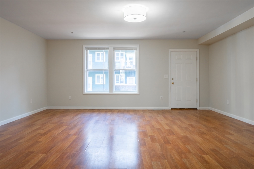 45 Chelsea Street, Unit 2 Boston, MA 02128 - Photo 5 of 10 a view of an empty room with wooden floor and a window