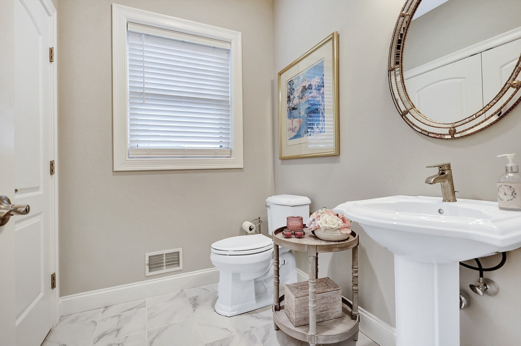 24 Del Ray Drive, Unit 25 Windham, NH 03087 - Photo 19 of 30 a bathroom with a toilet a sink and a mirror
